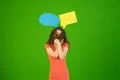 The woman stand with dialog signs on the green background Photo