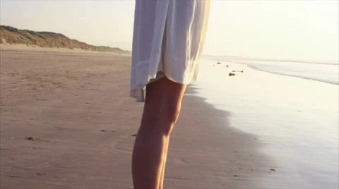 Woman standing with arms outstretched on beach Stock Footage 59057646