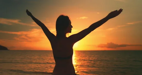 Woman standing on beach at sunset Stock Footage 277705633