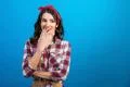 The woman standing on the blue background Photo