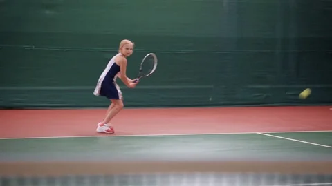 Woman standing in court with racket playing tennis Stock Footage