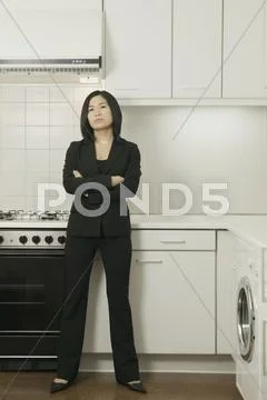 Woman standing in empty kitchen Stock Photos