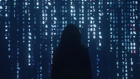 Woman Standing in Front of Large Computer Screen Scrolling Digital Binary Code Stock Footage 219594066