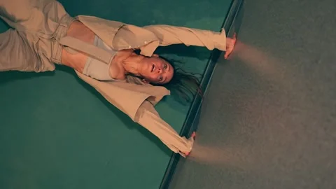 Woman is standing on hands upside down during practicing new dance in a studio Video stock 318546772