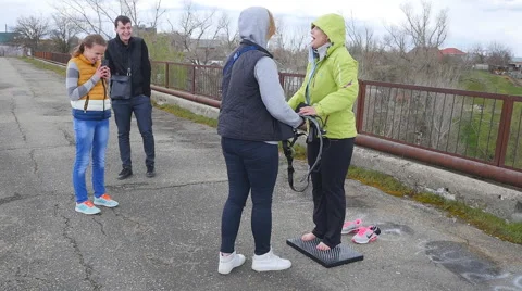 Woman standing on the nails before the instructor Stock Footage 68348538