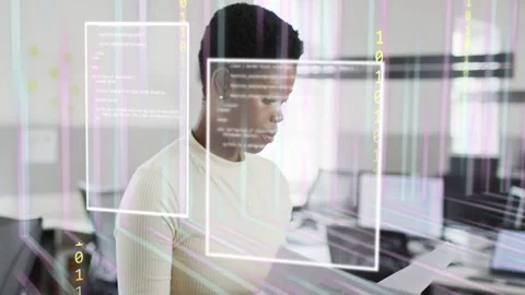 Woman standing reviewing documents in tech office turning pages causing AR Stock Footage 333425652