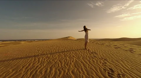Woman standing on sand dune Stock Footage