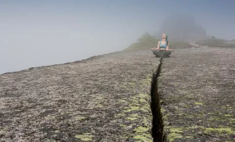 Woman standing on solid rock to avoid earthquake Stock Photos