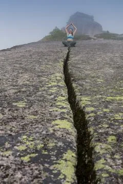 Woman standing on solid rock to avoid earthquake Stock Photos