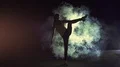 The woman standing in twine on a smoke cloud background. slow motion 4k or 4k+ Resolution
