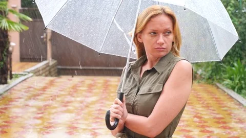 A woman is standing under an umbrella. Summer torrential downpour. 4k, slow Stock Footage