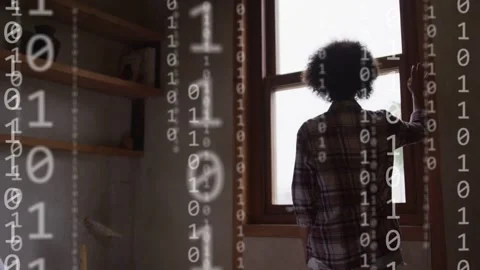 Woman standing window hand on frame watching binary forming tech network around Stock Footage 334013803