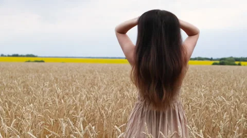 Woman stands with her back to camera touching her hair. Stock Footage 285386335