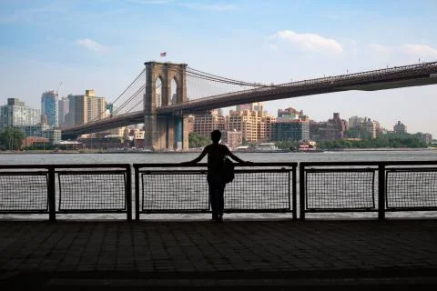 Woman Stands Looking at Brooklyn Bridge in New York City Stock Photos