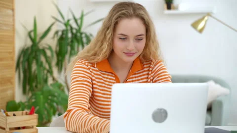 Woman start e-learning with device, open laptop at desk smile and search online Stock Footage 154922206