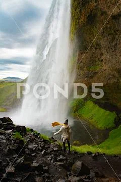 Woman stay on waterfall in Iceland, hide waterfall in Iceland, a Stock Photos
