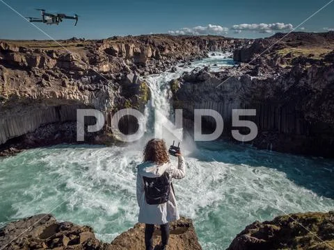 Woman stay on waterfall in Iceland, hide waterfall in Iceland, a Stock Photos