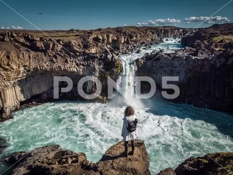 Woman stay on waterfall in Iceland, hide waterfall in Iceland, a Stock Photos