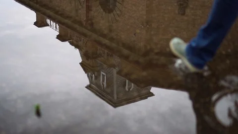 Woman stepped on a reflection in a puddle day Vídeo Stock 112004585