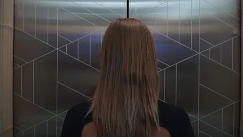 A woman steps out of an elevator Stock-Footage 170422025