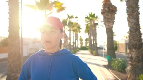 Woman stops while jogging to check the data in the smart watch application Stock Footage 115122241