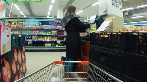Woman in the store checking weight on the scale Stock Footage 73542674