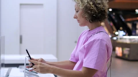 Woman in store tests camera before purchasing new phone. Quality and technical Stock Footage 257432337