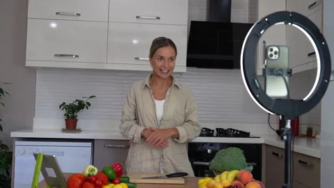 A woman streaming in the kitchen Stock Footage 281723976