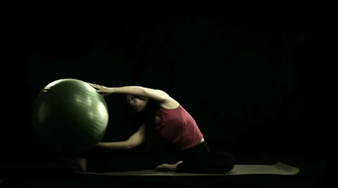 Woman stretches using exercise ball Stock Footage 33831384