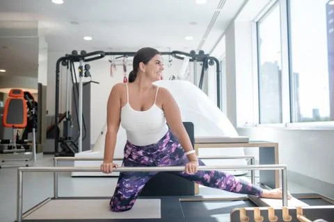 Woman stretching her hamstrings while doing exercises Stock Photos