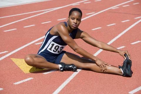 Woman Stretching On Race Track Stock Photos