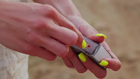 Woman Strikes Match to Create Flame in Outdoor Scene – Neon Nails Slow Motion Stock Footage 315077584