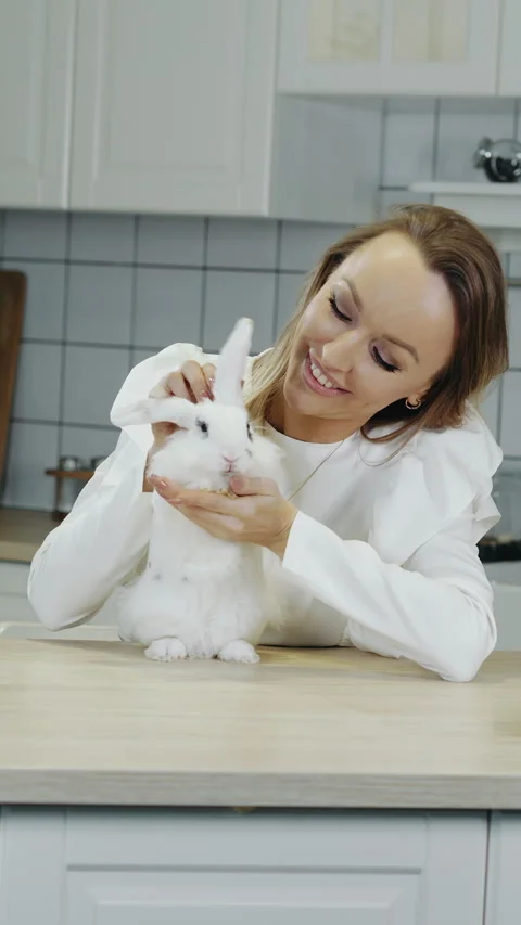 A woman stroking a white Easter bunny. Stock Footage 303622085