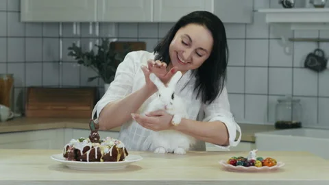 A woman stroking a white Easter bunny. Stock Footage 303622848