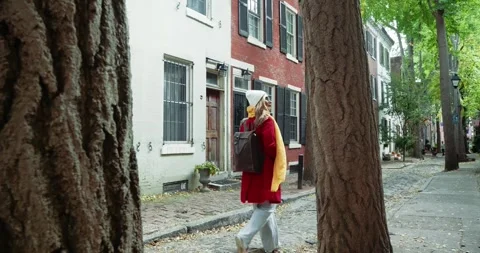 Woman Strolling Along Tree-Lined Street Stock Footage 323337371