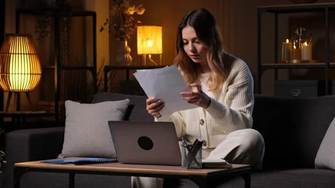 Woman Student Engaged In E-Learning Process With Paperwork And Laptop At Home Stock Footage 281861528