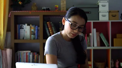 Woman student writing on book for study with online teacher Stock Footage 129018828