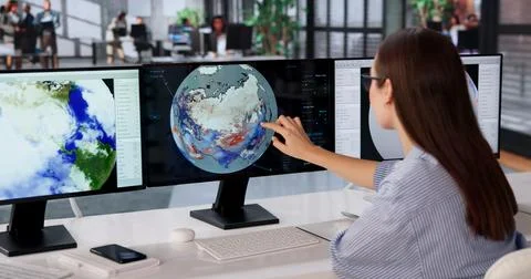 Woman Studies Climate Data On Computer Screen To Predict Weather Changes. Stock Photos