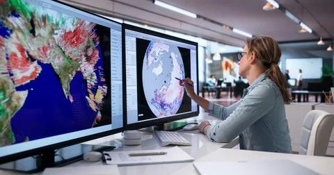 Woman Studies Cyclone Map On Computer, Tracking Weather Changes Closely. Stock-Fotos