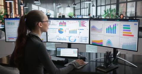 Woman Studies Financial Data On Computer Screen To Support Business Planning. Stock Photos