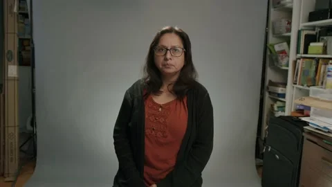 Woman in studio getting ready to talk on camera Stock Footage 237765309