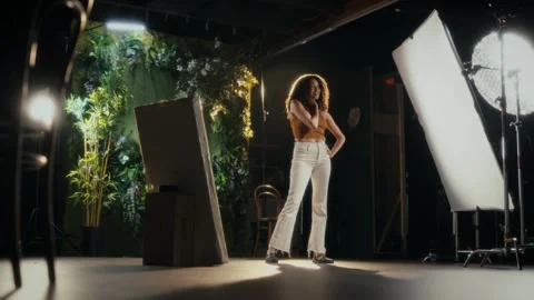 A woman in a studio setting, modelling and posing  Stock Footage 312443689