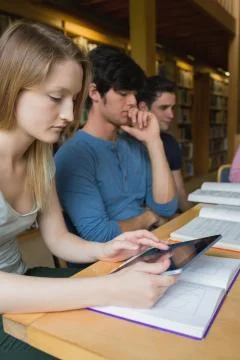 Woman in study group using tablet pc Stock Photos