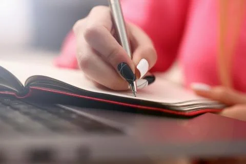 Woman study hard write down information to notebook Stock Photos