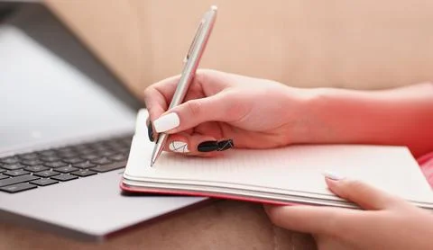 Woman study hard write down information to notebook Stock Photos