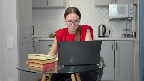 Woman studying and taking notes at home Stock Footage 307308730