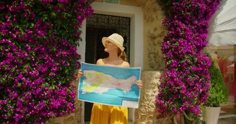 Woman studying Capri map between blooming bougainvillea walls during tourist Stock-Footage 341295200