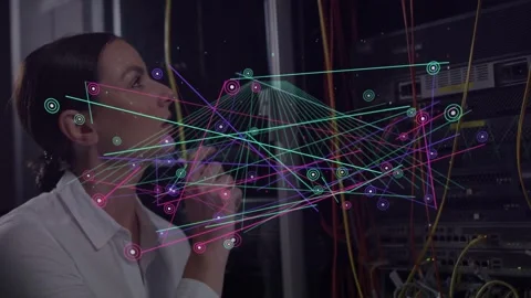 Woman studying server rack, initiating holographic network highlighting nodes Stock Footage 333901220