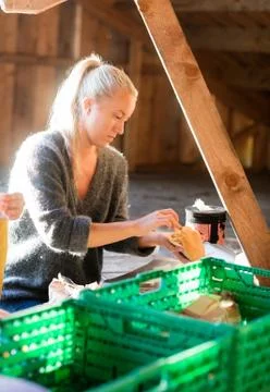Woman Stuffing Bread While Preparing Meal In Shed Stock Photos
