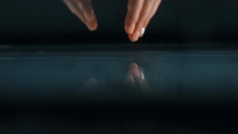 Woman submerging her hands in a pool in slow motion Stock Footage 88439010